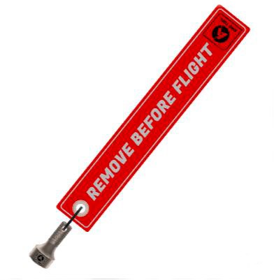 Etiqueta de seguridad roja con texto “Remove Before Flight”.